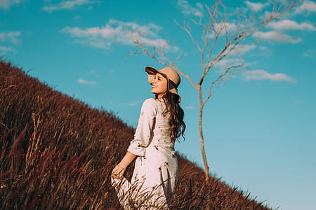 woman on wheat field during daytime thumbnail