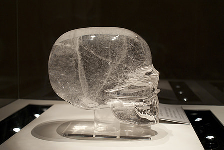 clear glass skull figurine on table thumbnail