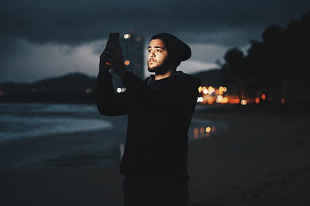 man's taking picture by himself on beach thumbnail