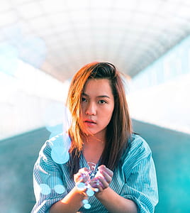 woman in blue dress in bokeh effect photography thumbnail