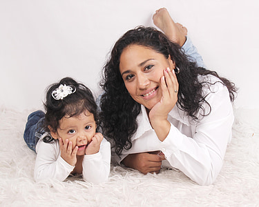 woman and child in white lying on white textile thumbnail