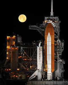 selective focus photo of space shuttle at nighttime thumbnail