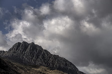gray rock formation under cloudy sky thumbnail
