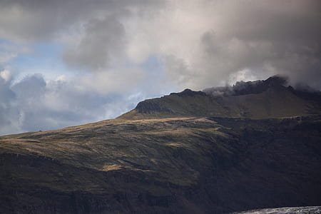 mountain range covered with clouds at daytime thumbnail
