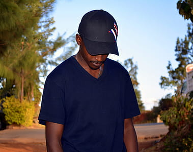 Man Wearing Black Fitted Cap And Black V-neck T-shirt thumbnail