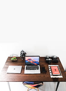 MacBook Pro turned on on brown wooden table thumbnail