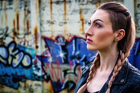 close up photo of a woman wearing leather jacket looking up thumbnail