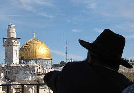 man wearing black hat near temple during day thumbnail