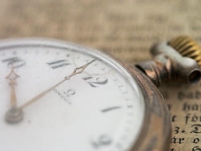 closeup selective focus photography of gold-colored pocket watch thumbnail