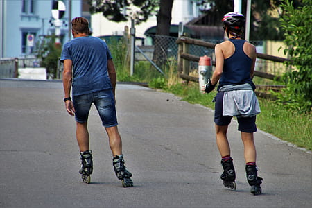two man skating in middle of road thumbnail