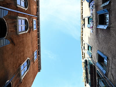 brown and gray buildings under sunny sky thumbnail