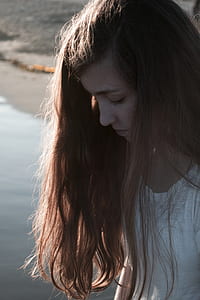 woman in white shirt looking down thumbnail