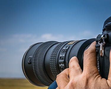 person holding black DSLR camera thumbnail