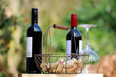 two wine bottles near gray metal basket thumbnail
