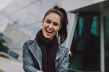 woman holding sparkler while smiling thumbnail