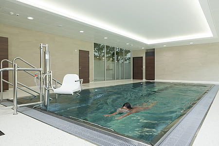 woman swimming in indoor pool thumbnail
