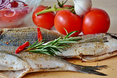 raw fish beside tomatoes thumbnail