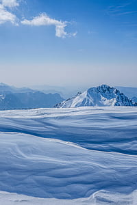 white snow near mountains at daytime thumbnail