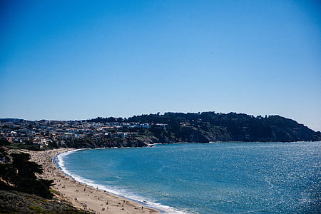 several people on beach shore with blue beach under blue sky thumbnail