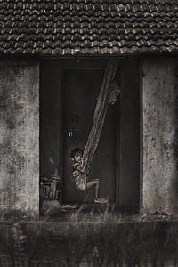 grayscale photography of toddler sits on swing thumbnail