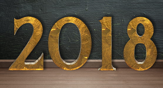 gold 2018 freestanding numbers on top of brown wooden surface thumbnail