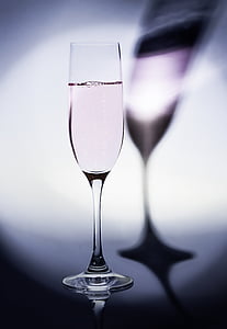 clear long-stemmed wine glass filled with pink liquid thumbnail