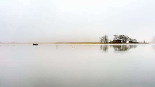 photograph of two persons on boat near shore thumbnail