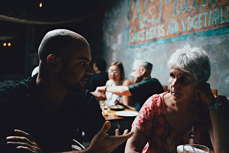 man wearing black shirt talking to woman thumbnail
