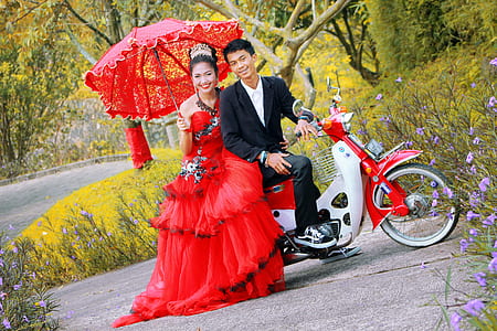 man and woman sitting on motor scooter thumbnail