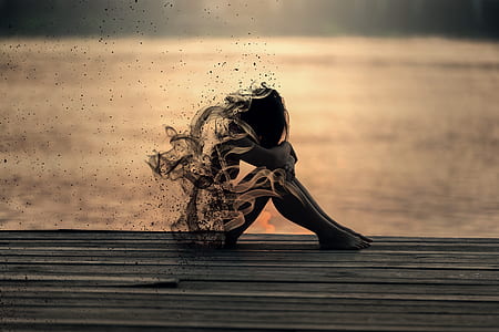 silhouette photo of woman sitting near dock thumbnail