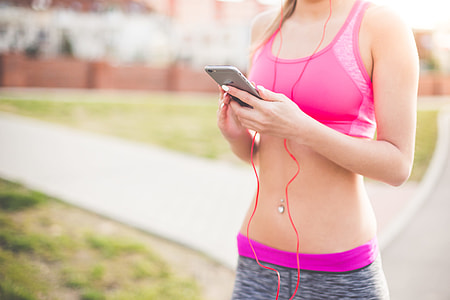 Fitness Girl Listening to Streaming Music on Her Phone thumbnail