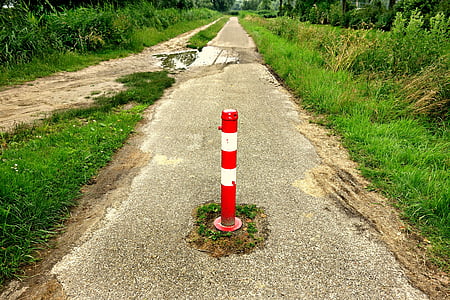 red traffic post between gray asphalt road thumbnail
