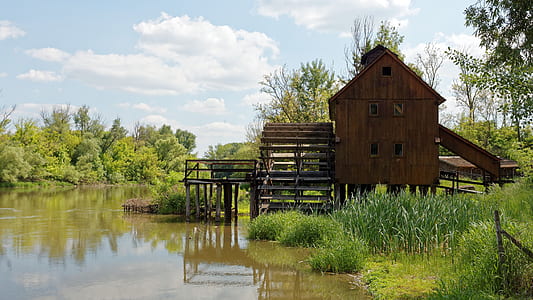 brown wooden shed on lake thumbnail