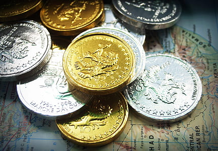 low light photography of pile of coins thumbnail
