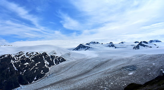snow covered land under blue sky thumbnail