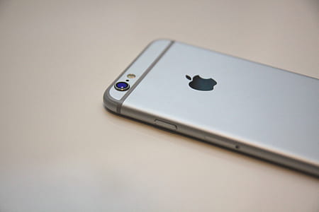 space gray iPhone 6 on top of white surface thumbnail