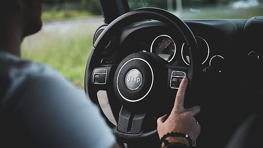 person holding car steering wheel thumbnail