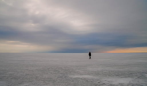 Silhouette of Person Walking on Vast Land thumbnail