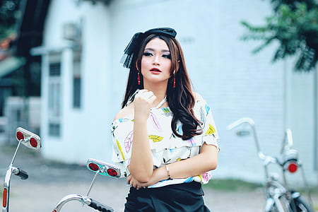 woman in white printed top posing for photo thumbnail