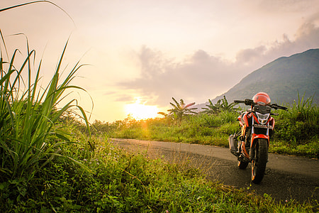 black motorcycle near the grass thumbnail