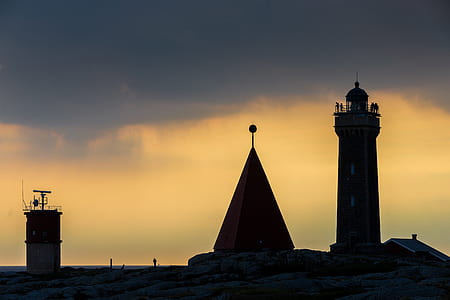 silhouette of lighthouse near body of water thumbnail