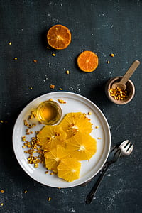 sliced lemon on plate beside forks thumbnail