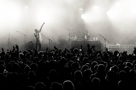 grayscale photo of man on stage with smoke effects thumbnail
