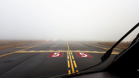 person in aircaft on gray runway thumbnail