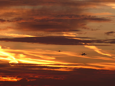 two flying planes above clouds during golden hour thumbnail