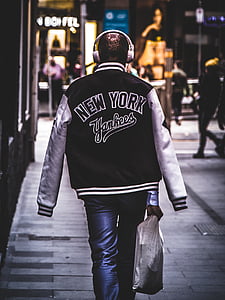 person wearing New York jacket walking through building thumbnail