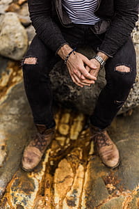 man sitting on rock thumbnail