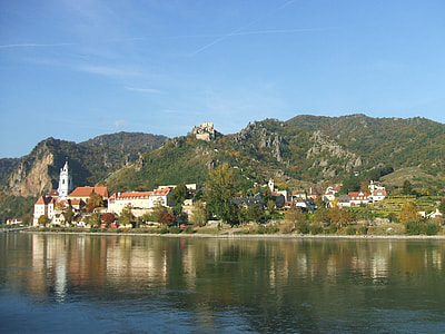 photo of white building near mountain at daytime thumbnail