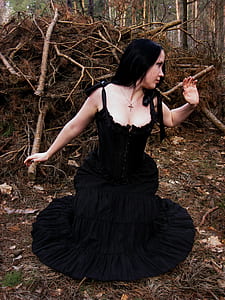 woman wearing black sleeveless dress on forest thumbnail