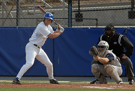 man playing baseball in field thumbnail